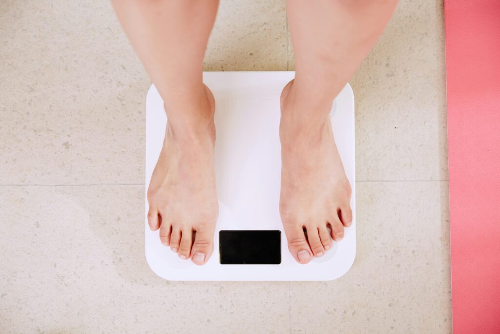 Woman weighing herself on scales